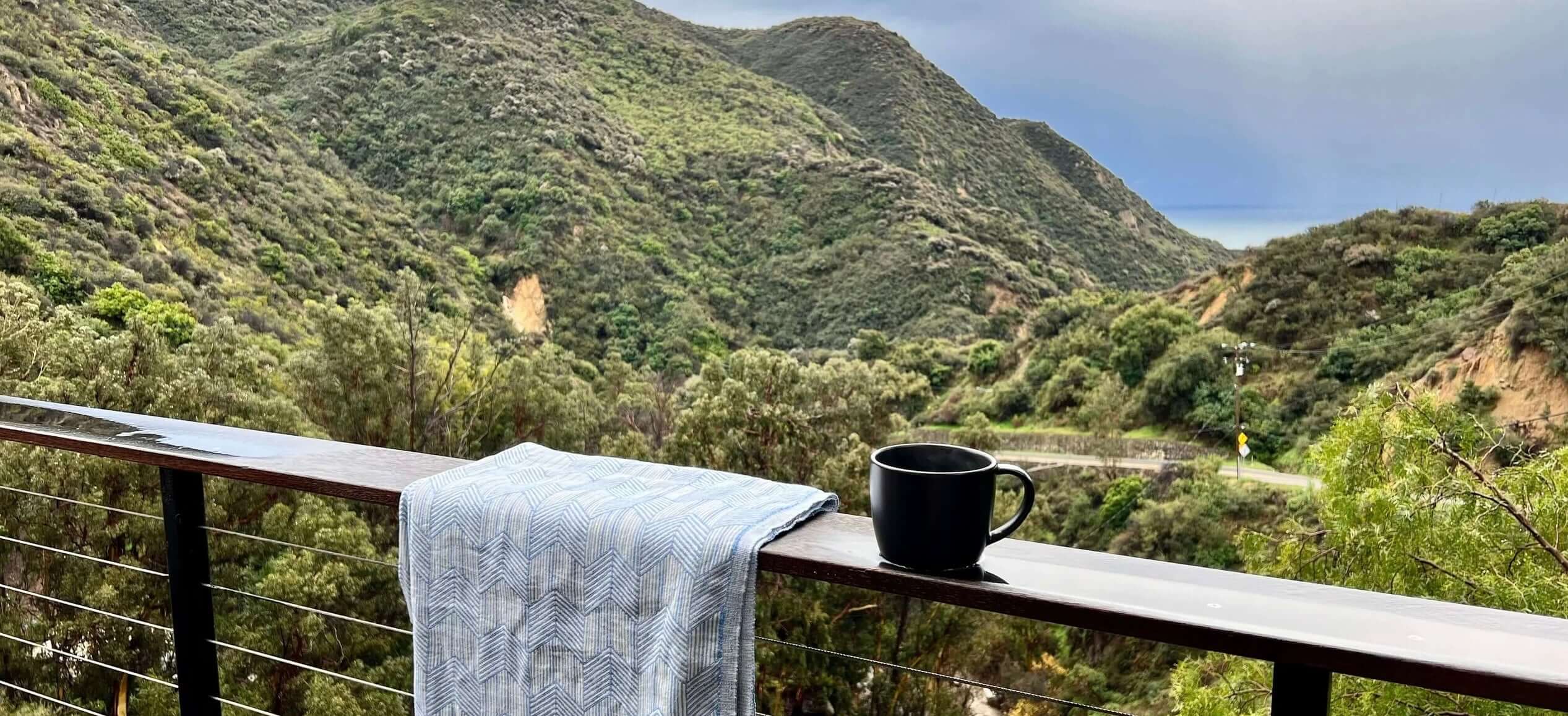 Malibu California mountain scene with Sol Siren Porto Beach Towel and coffee mug